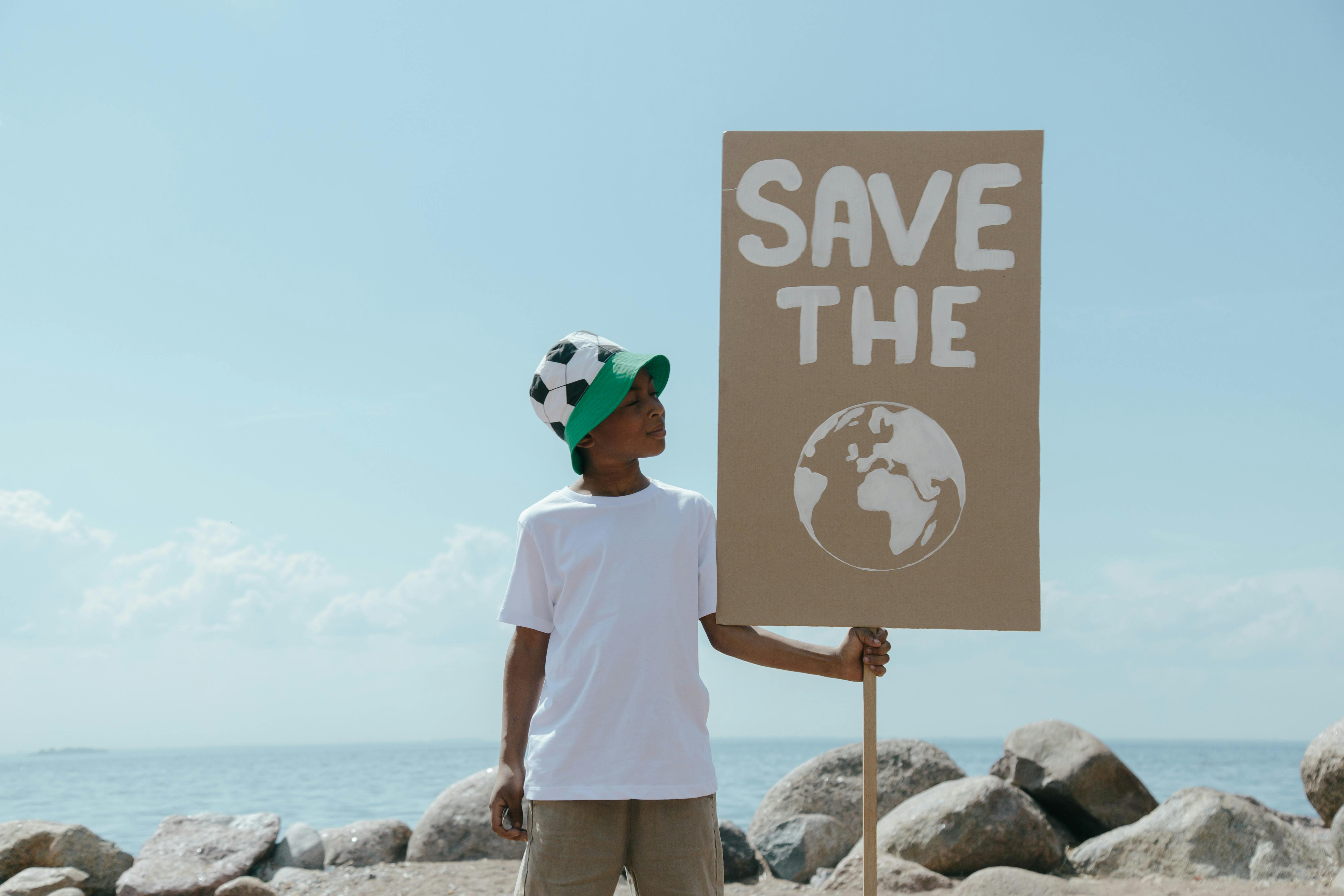 Child holding environmental conservation sign